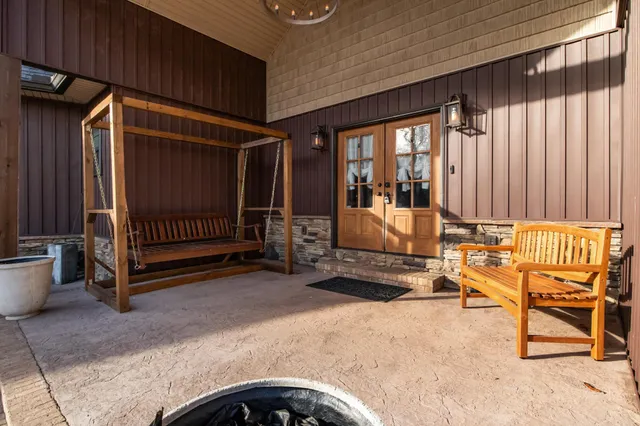 a large kitchen with stainless steel appliances kitchen island granite countertop a table and chairs in it