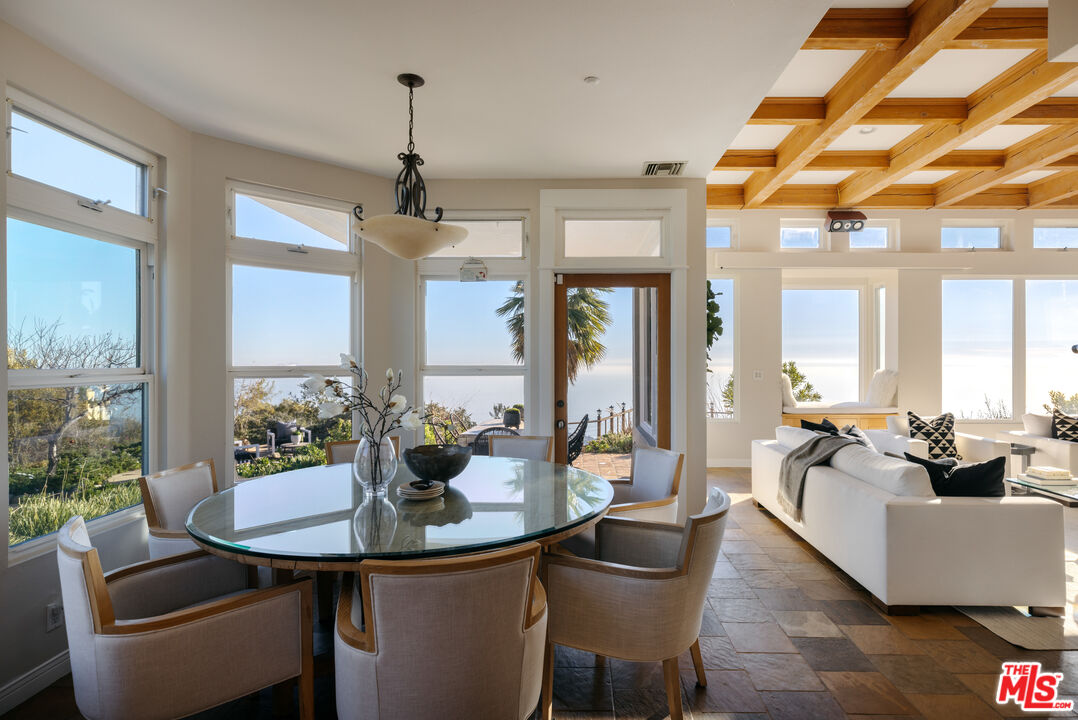 401 Moonrise Drive Malibu, CA 90265 - Photo 11 of 47 a dining room with furniture a chandelier and wooden floor