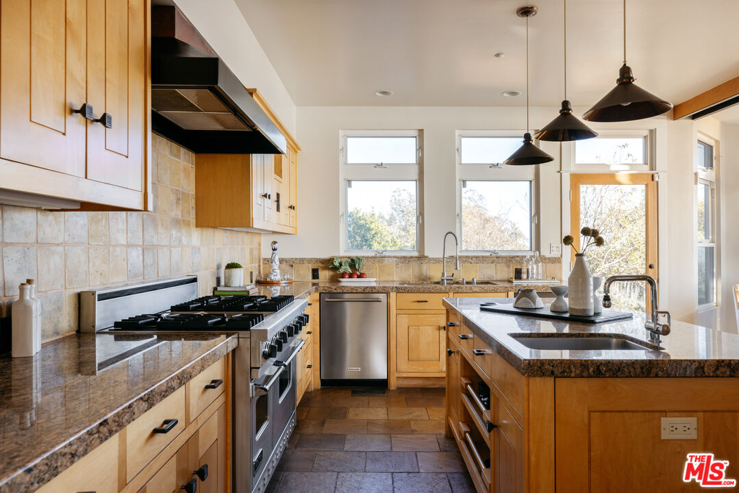 401 Moonrise Drive Malibu, CA 90265 - Photo 12 of 47 a kitchen with a sink a stove and cabinets