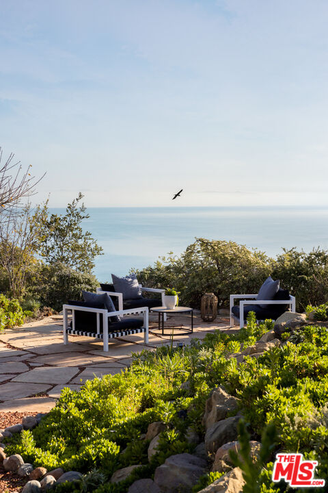 401 Moonrise Drive Malibu, CA 90265 - Photo 16 of 47 a view of a swimming pool with an outdoor seating