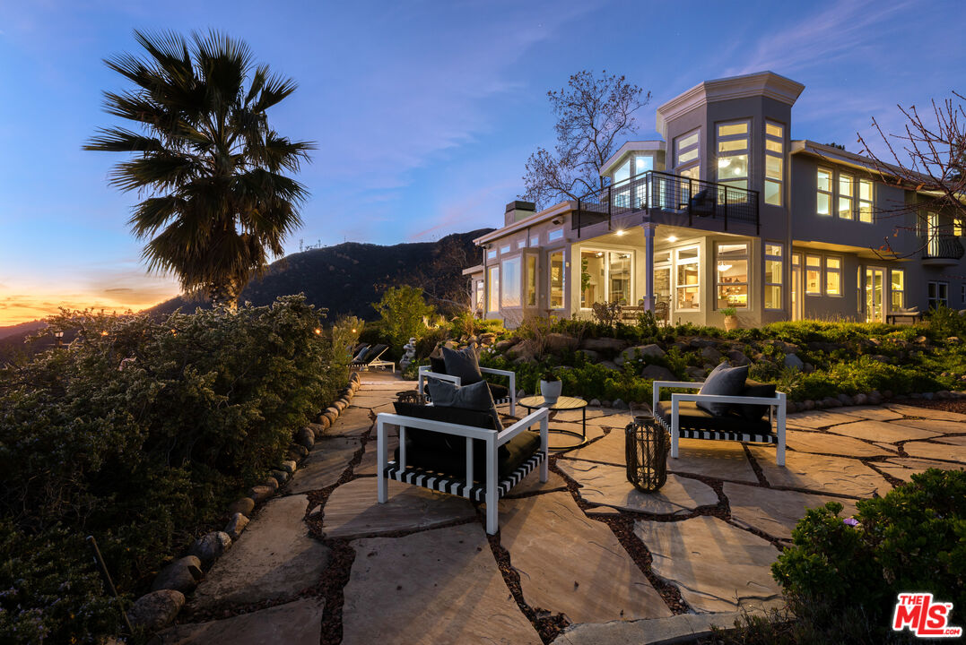 401 Moonrise Drive Malibu, CA 90265 - Photo 2 of 47 a view of a chairs and table in a patio