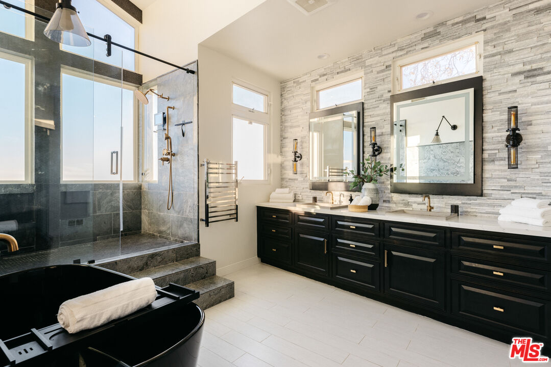 401 Moonrise Drive Malibu, CA 90265 - Photo 23 of 47 a bathroom with a sink double vanity shower and a mirror