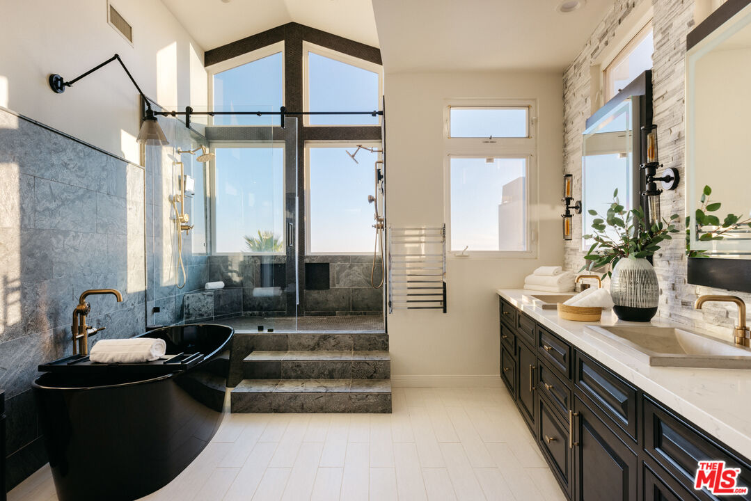 401 Moonrise Drive Malibu, CA 90265 - Photo 24 of 47 a spacious bathroom with a double vanity sink a mirror and a shower