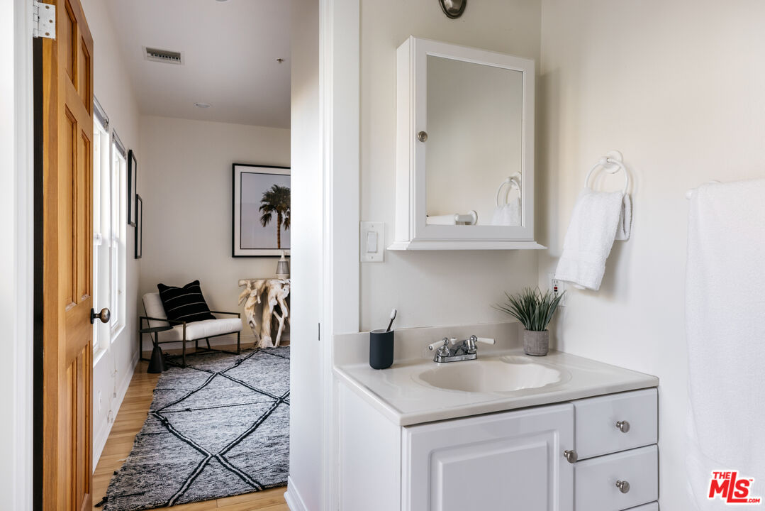 401 Moonrise Drive Malibu, CA 90265 - Photo 33 of 47 a en suite bathroom with a sink and a mirror