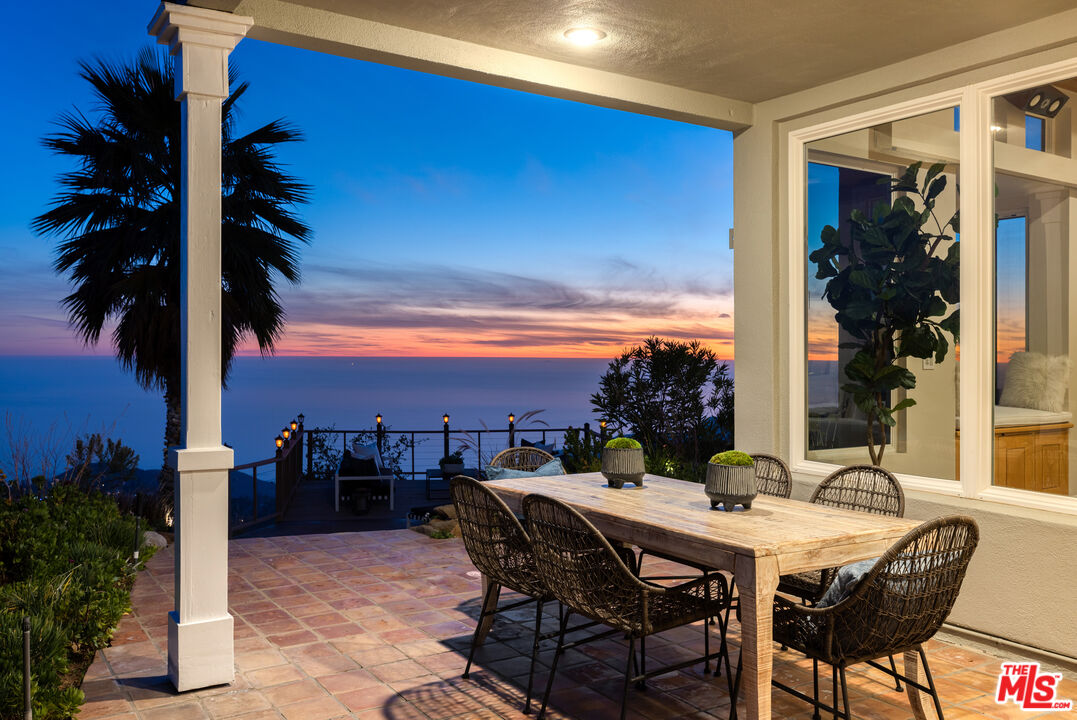 401 Moonrise Drive Malibu, CA 90265 - Photo 40 of 47 a view of a dinning table and chairs in patio