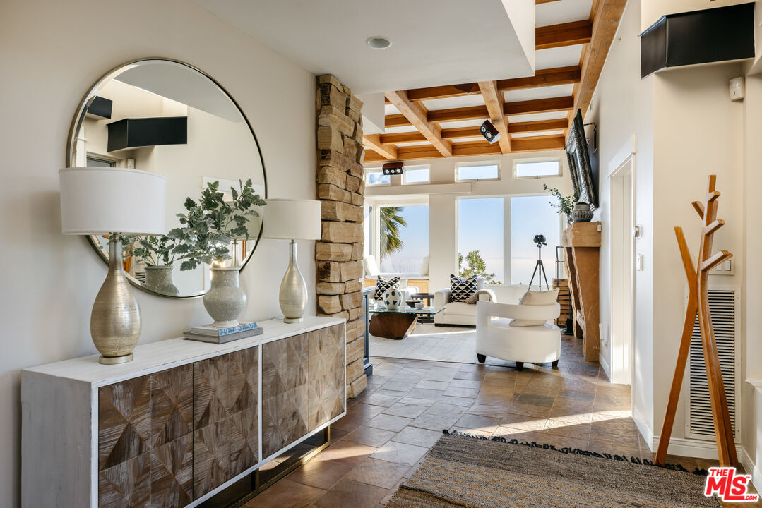 401 Moonrise Drive Malibu, CA 90265 - Photo 6 of 47 a living room with fireplace furniture and a potted plant