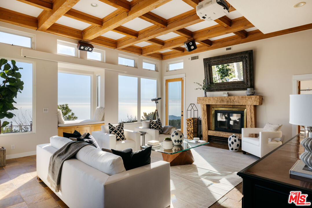 401 Moonrise Drive Malibu, CA 90265 - Photo 8 of 47 a living room with furniture and a fireplace