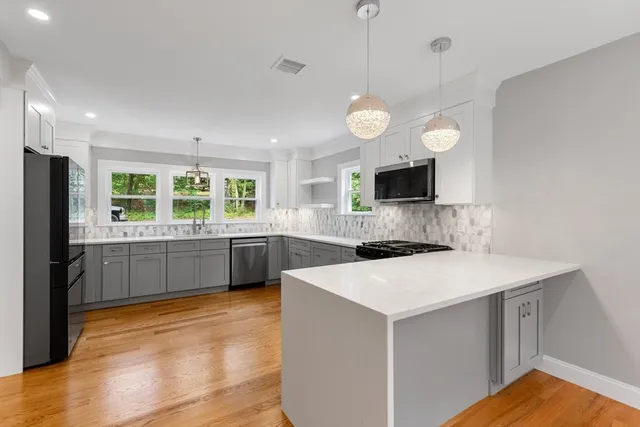 a kitchen with a stove a sink and a refrigerator