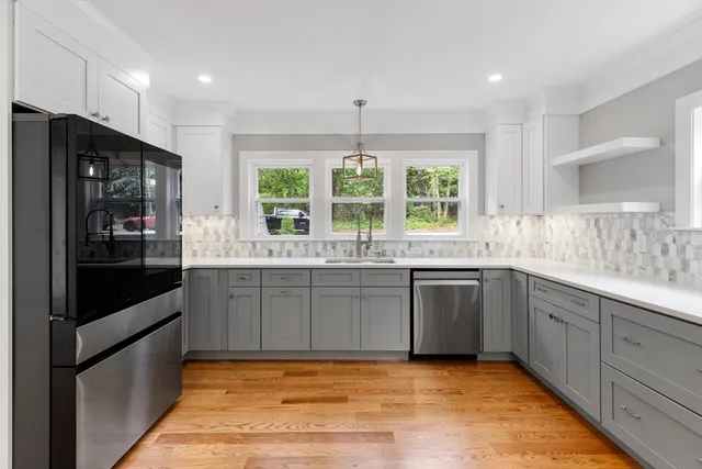 a kitchen with stainless steel appliances granite countertop a stove and a sink