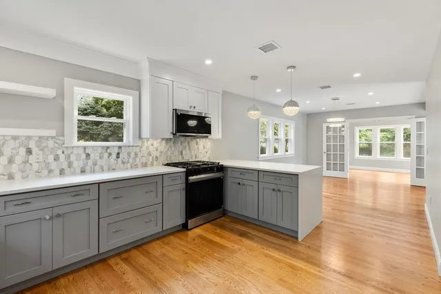 a large kitchen with a window and a sink