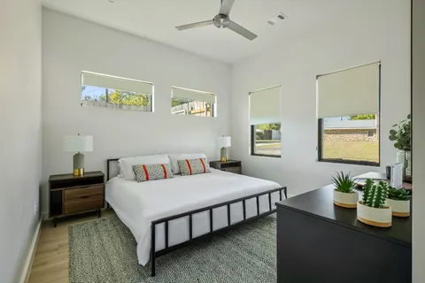 a bedroom with a bed table and bed