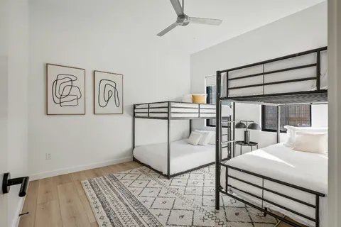 a bedroom with a bed and glass door