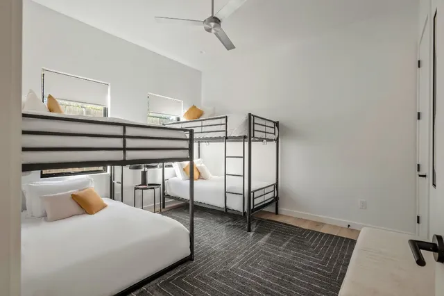 a bedroom with a bed a table and painting on the wall