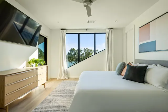 a bedroom with a bed and a flat screen tv