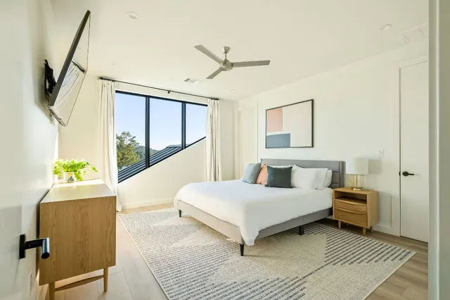 a living room with a bed furniture and a window