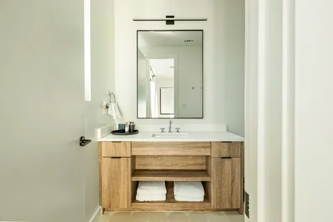 a bathroom with a sink vanity and mirror