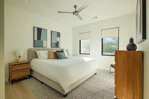 a bedroom with a bed and wooden floor