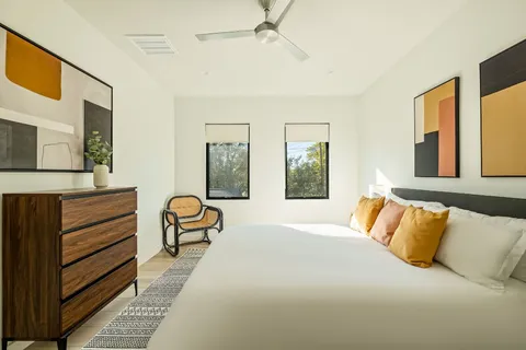 a bedroom with a bed and wooden floor