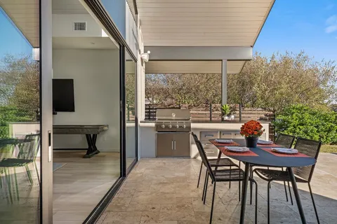 a dining room with furniture and a window