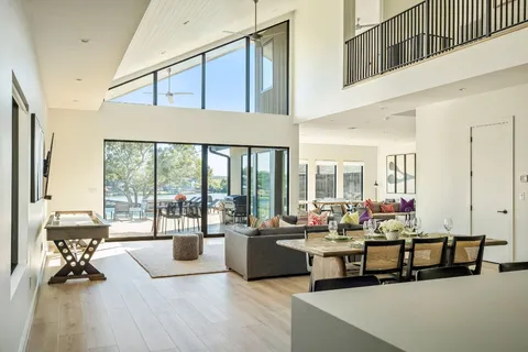 a living room with furniture and floor to ceiling windows