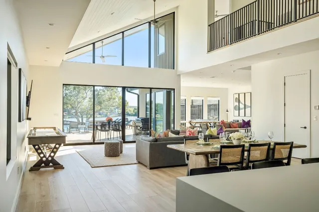 a living room with furniture and floor to ceiling windows