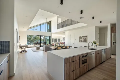 a large white kitchen with a large window