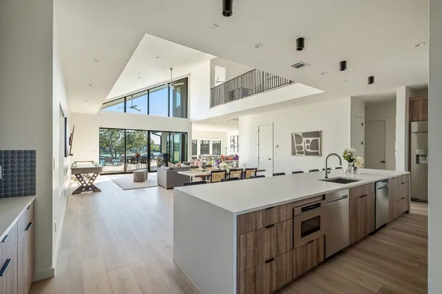 a large white kitchen with a large window