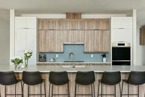 a kitchen with a table chairs sink and cabinets