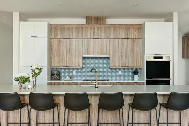 a kitchen with a table chairs sink and cabinets