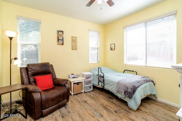 a bedroom with a bed chair and a window