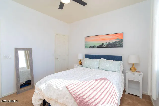 a bedroom with a bed and a painting on the wall