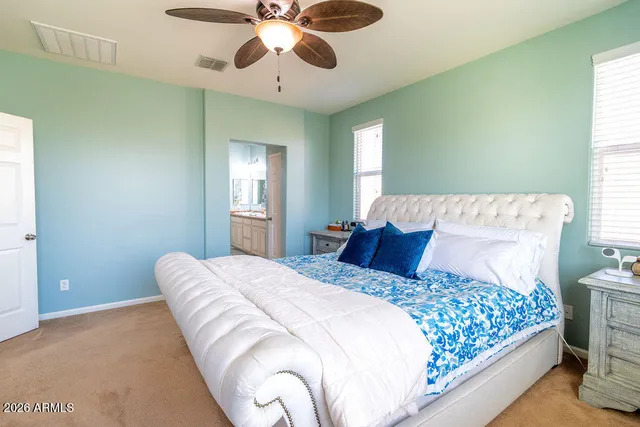 a bedroom with a large bed and a chandelier