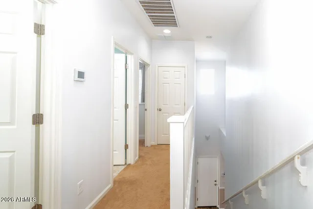 a view of a bathroom from a hallway