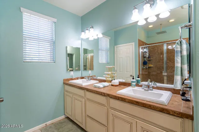 a bathroom with a double vanity sink and a mirror