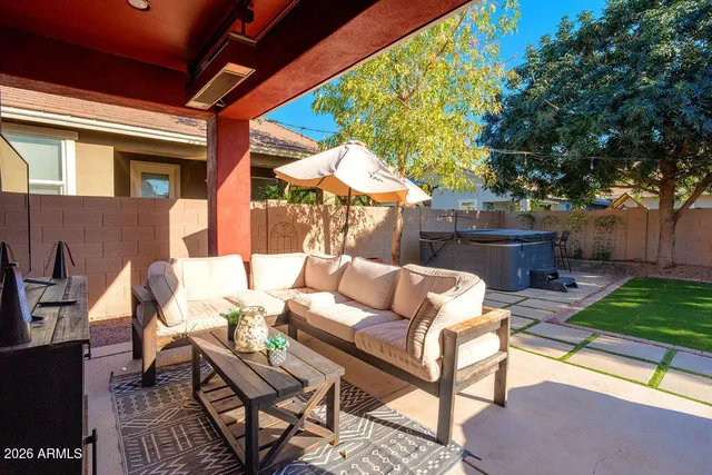 a view of a patio with a dining table and chairs with wooden floor and fence