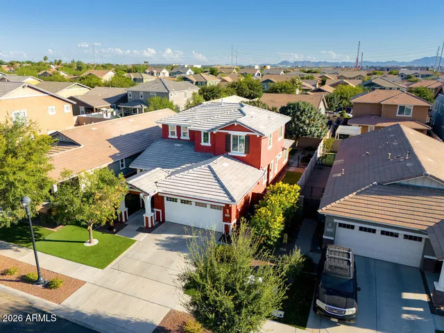 an aerial view of a house with a garden and lake view