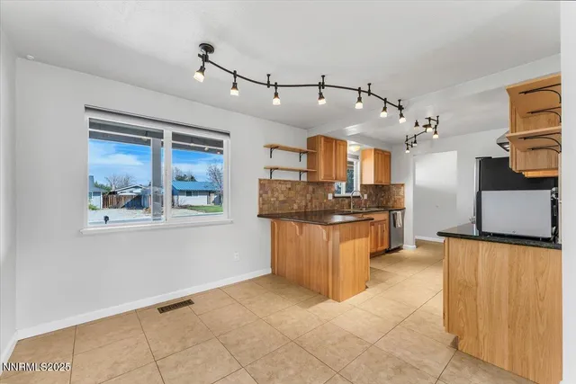 a kitchen with stainless steel appliances granite countertop a stove and a refrigerator