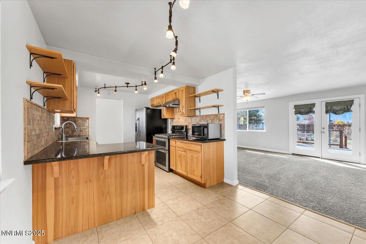 1275 Bolivia Way Gardnerville, NV 89460 - Photo 16 of 59 a large kitchen with kitchen island a large counter space a sink and appliances