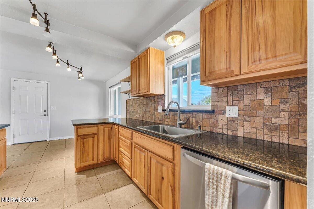 1275 Bolivia Way Gardnerville, NV 89460 - Photo 19 of 59 a kitchen with stainless steel appliances granite countertop a sink and cabinets