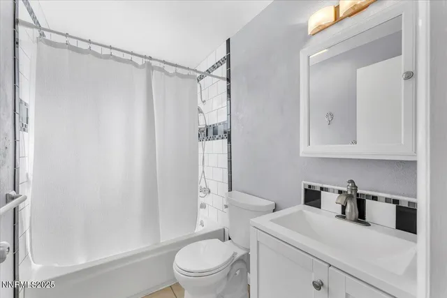 an empty room with ceiling fan and window