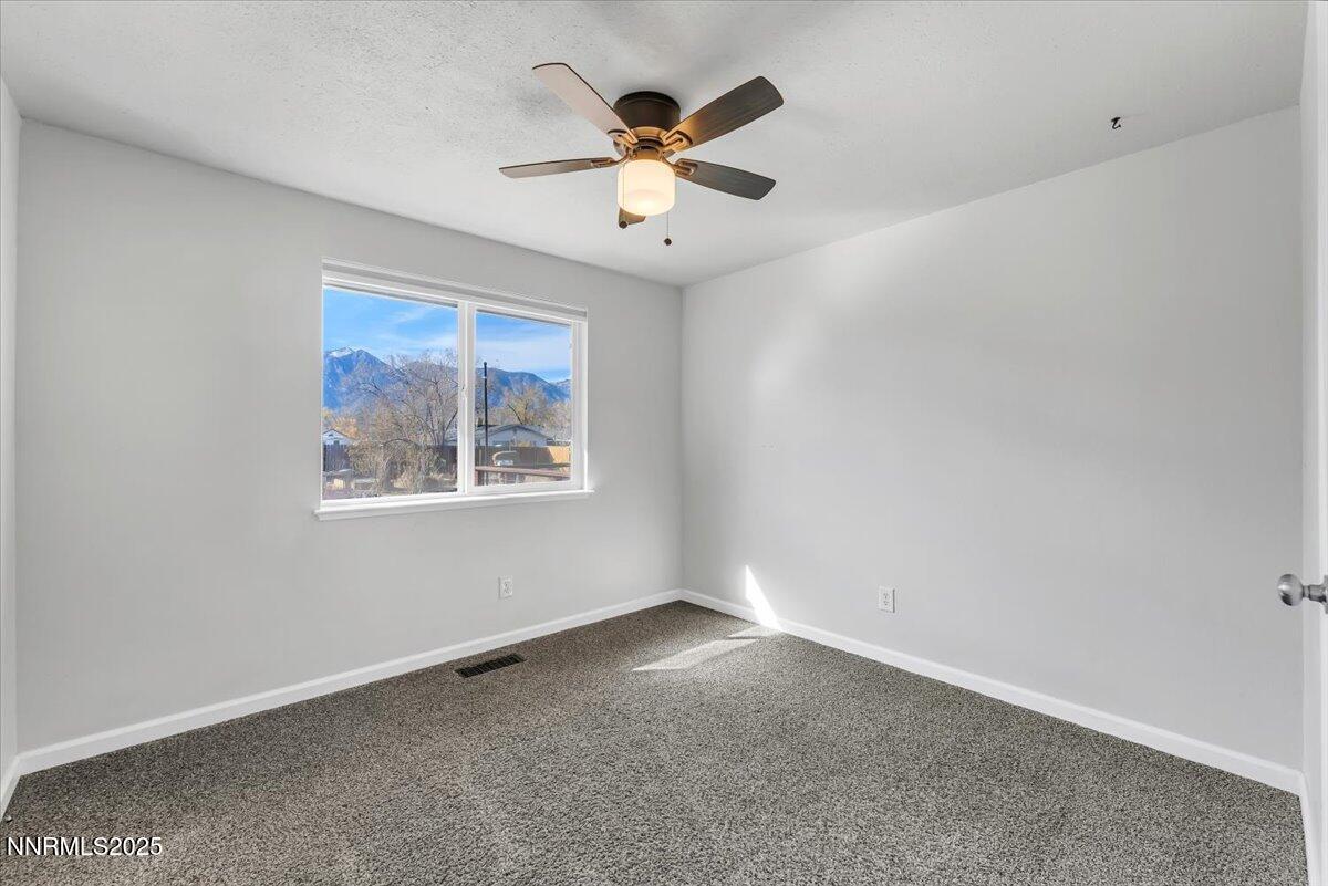 1275 Bolivia Way Gardnerville, NV 89460 - Photo 27 of 59 an empty room with ceiling fan and window