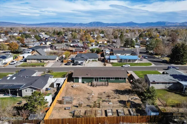 an aerial view of residential house and car parked