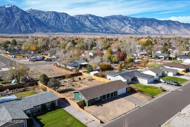 an aerial view of residential building with green space