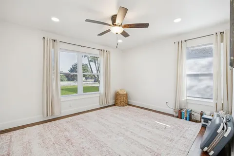 a view of a livingroom with a ceiling fan and window
