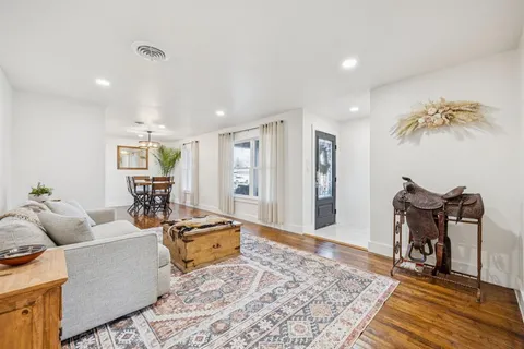 a living room with furniture and a rug