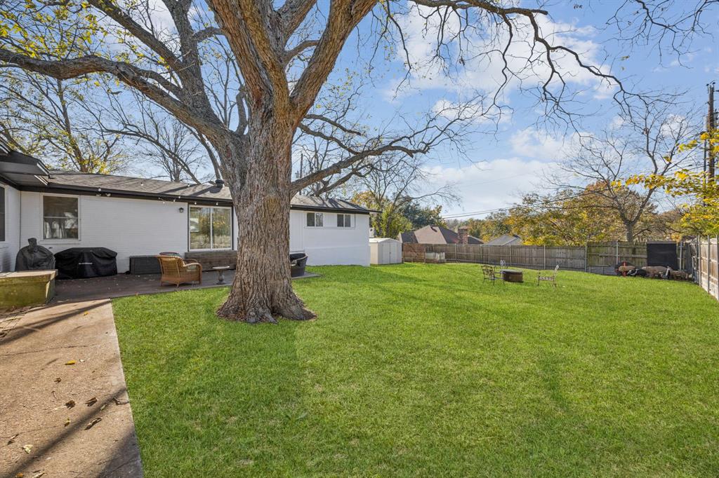 207 Joe White Street Rockwall, TX 75087 - Photo 26 of 27 a view of a backyard with large trees