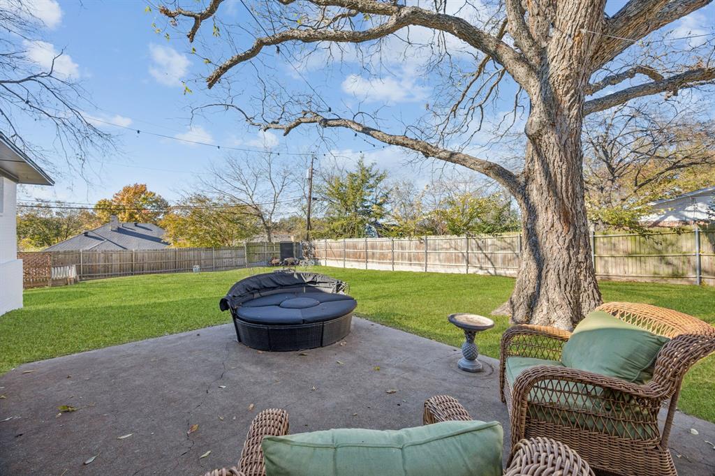 207 Joe White Street Rockwall, TX 75087 - Photo 27 of 27 a view of a backyard with couches plants and large trees