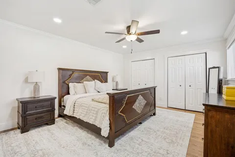 a spacious bedroom with a bed and a chandelier