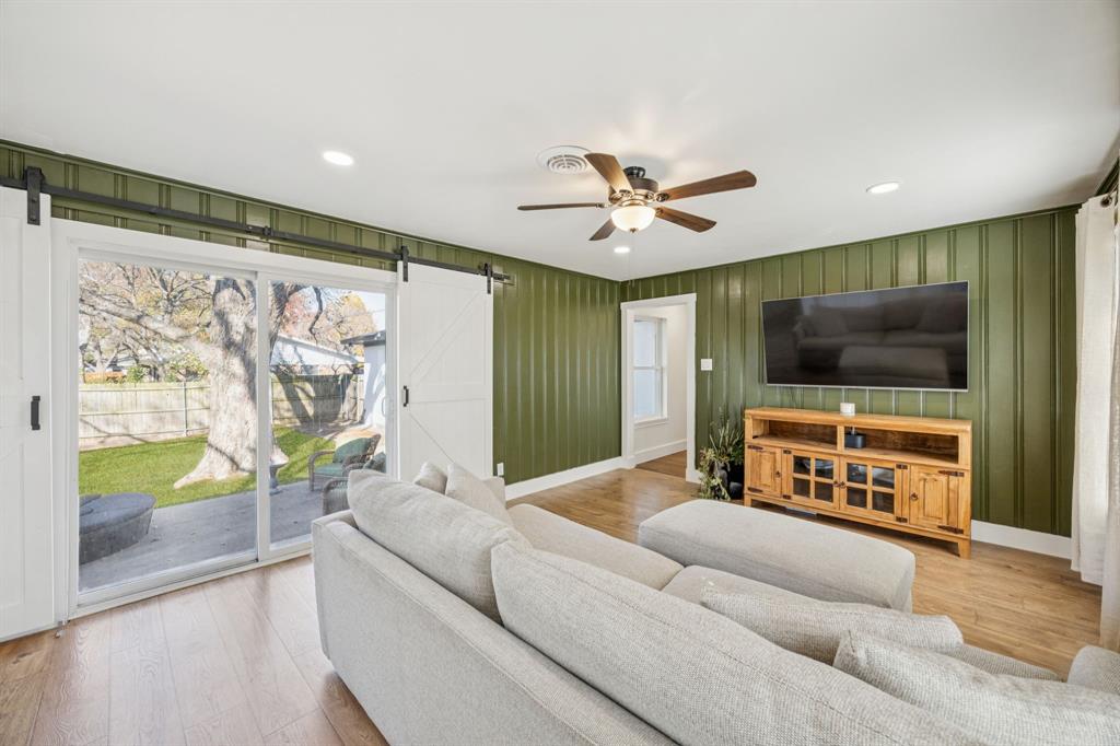 207 Joe White Street Rockwall, TX 75087 - Photo 10 of 27 a living room with furniture and a flat screen tv