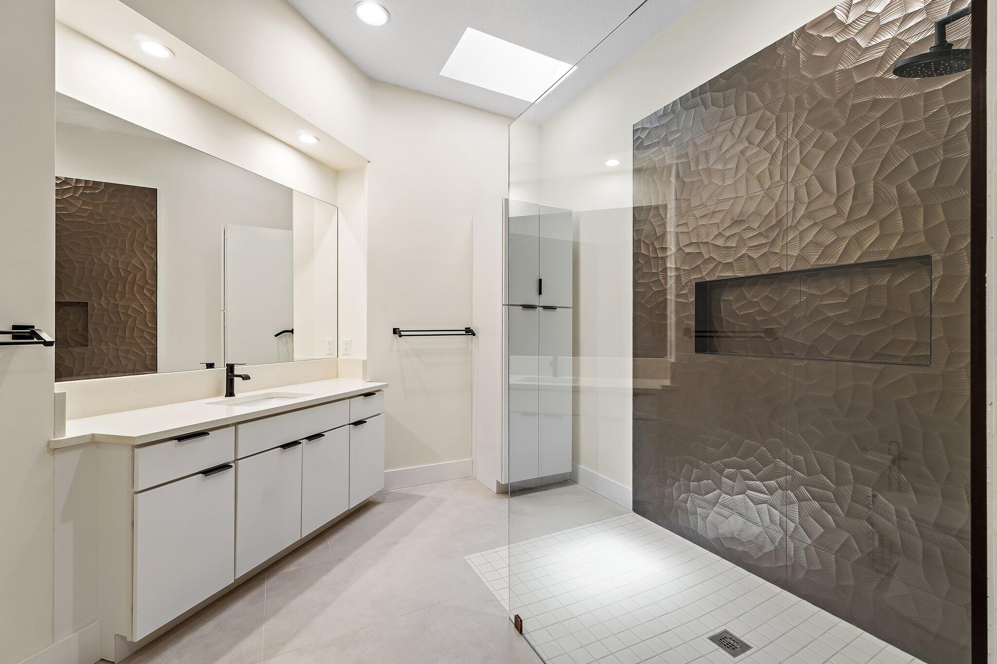 173 East Hampton Way Jupiter, FL 33458 - Photo 18 of 28 a bathroom with a double vanity sink a toilet and shower